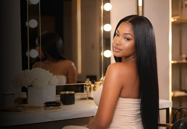 Woman with sleek straight human hair wig in an elegant vanity mirror setting - Sleek & Sophisticated banner